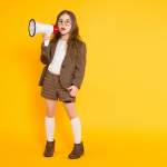  Young girl with megaphone directing a school media program